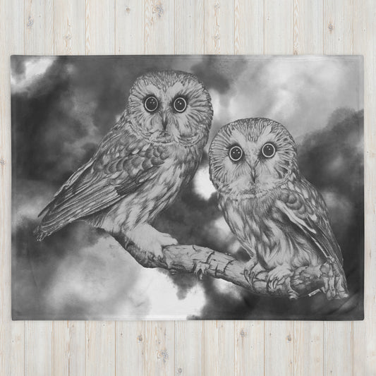 The "Owl Throw Blanket" is of two owls sitting on a branch with a "Who's That" look, drawn with a graphite pencil with a gray and white cloud effect added to give it a dynamic look.