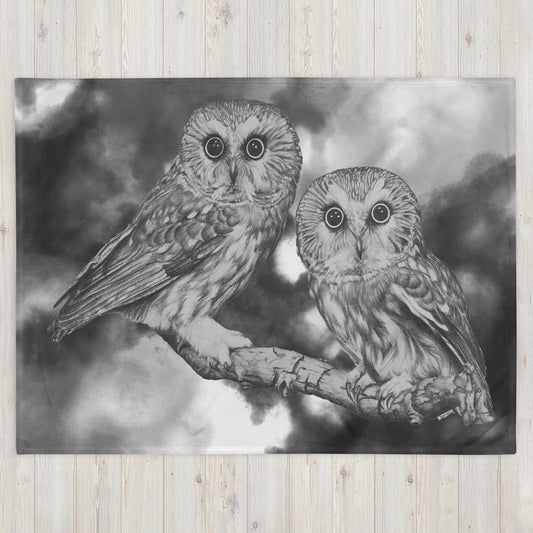 The "Owl Throw Blanket" is of two owls sitting on a branch with a "Who's That" look, drawn with a graphite pencil with a gray and white cloud effect  added to give it a dynamic look.
