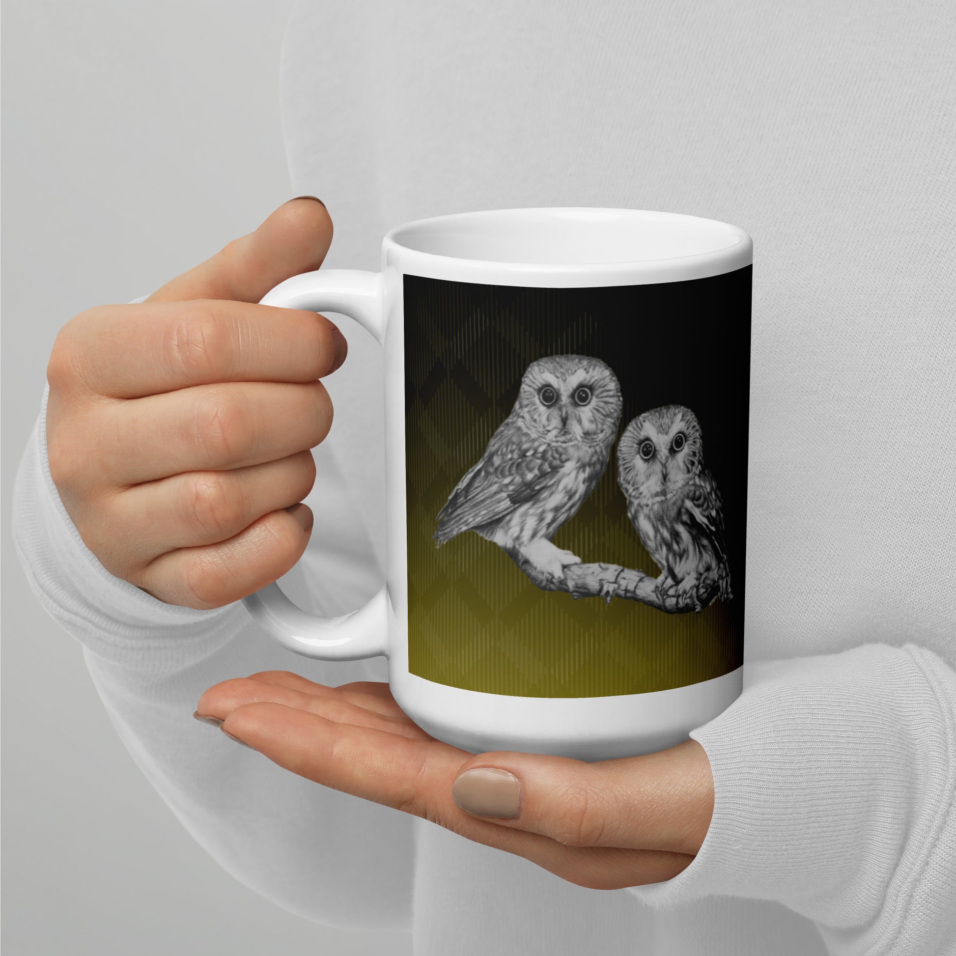 The "Owl White Glossy Mug" is of two owls sitting on a branch with a "Who's That" look, drawn with a graphite pencil on Hammermill Bond paper.